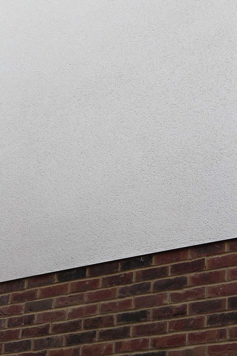 rug red brick wall and plain white concrete wall wall