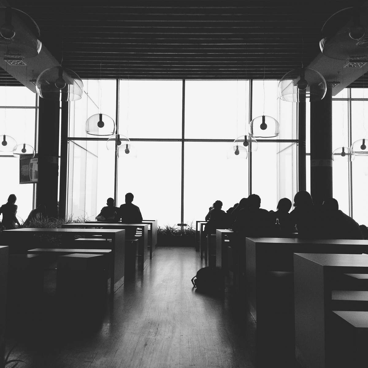black-and-white silhouette of people inside room with lights turned off people
