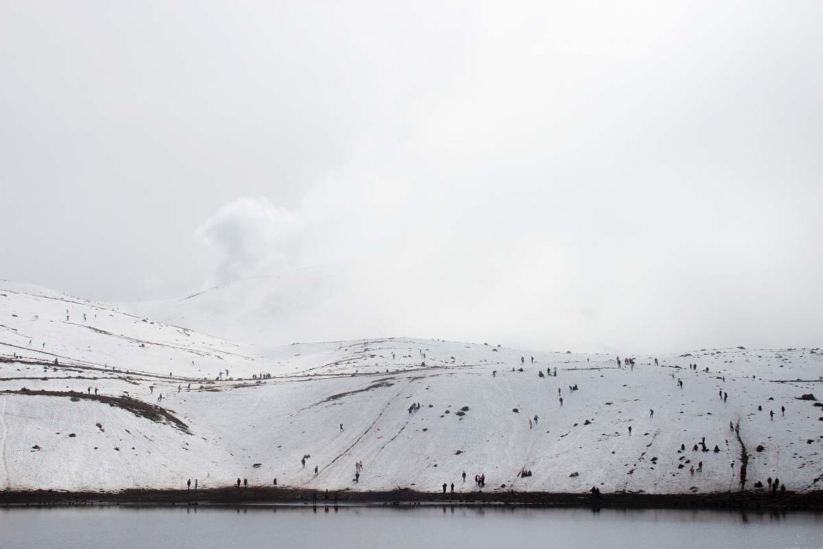 snow snow-covered land near body of water lake