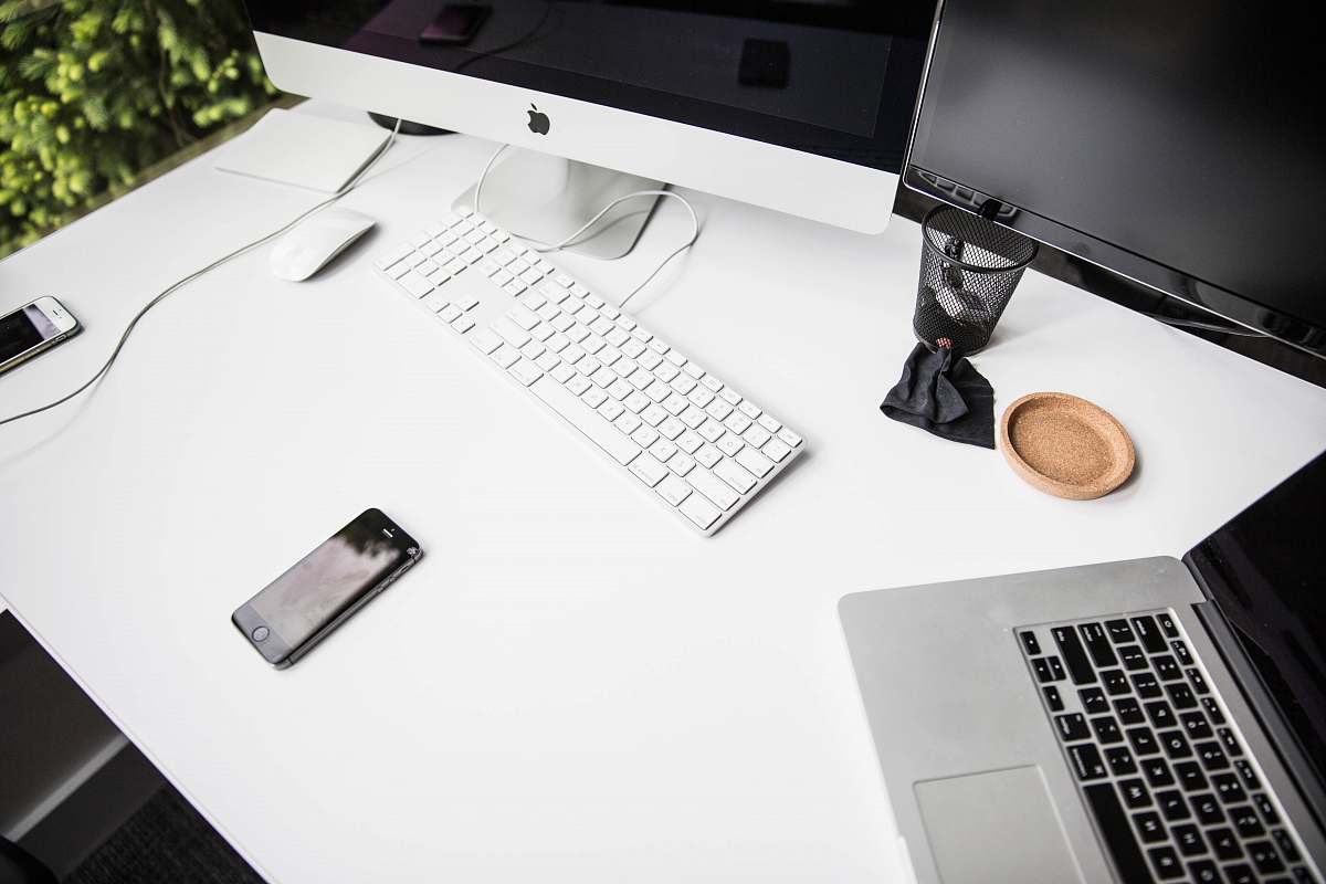 computer space gray iPhone 6 on table near magic keybord laptop