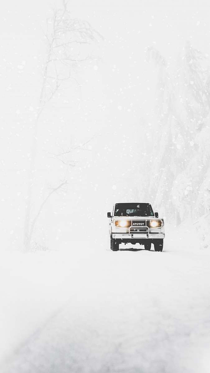 winter Toyota SUV covered with snow snow