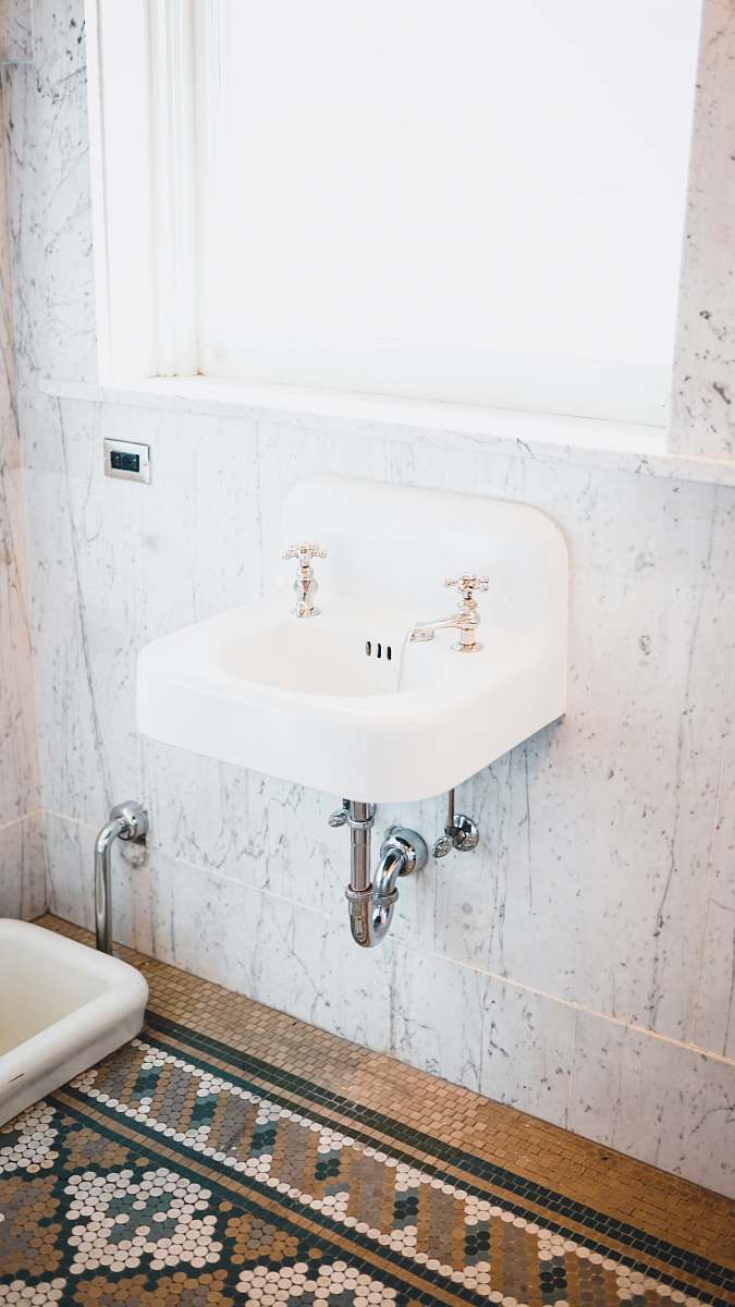 sink two faucet on sink near window indoors