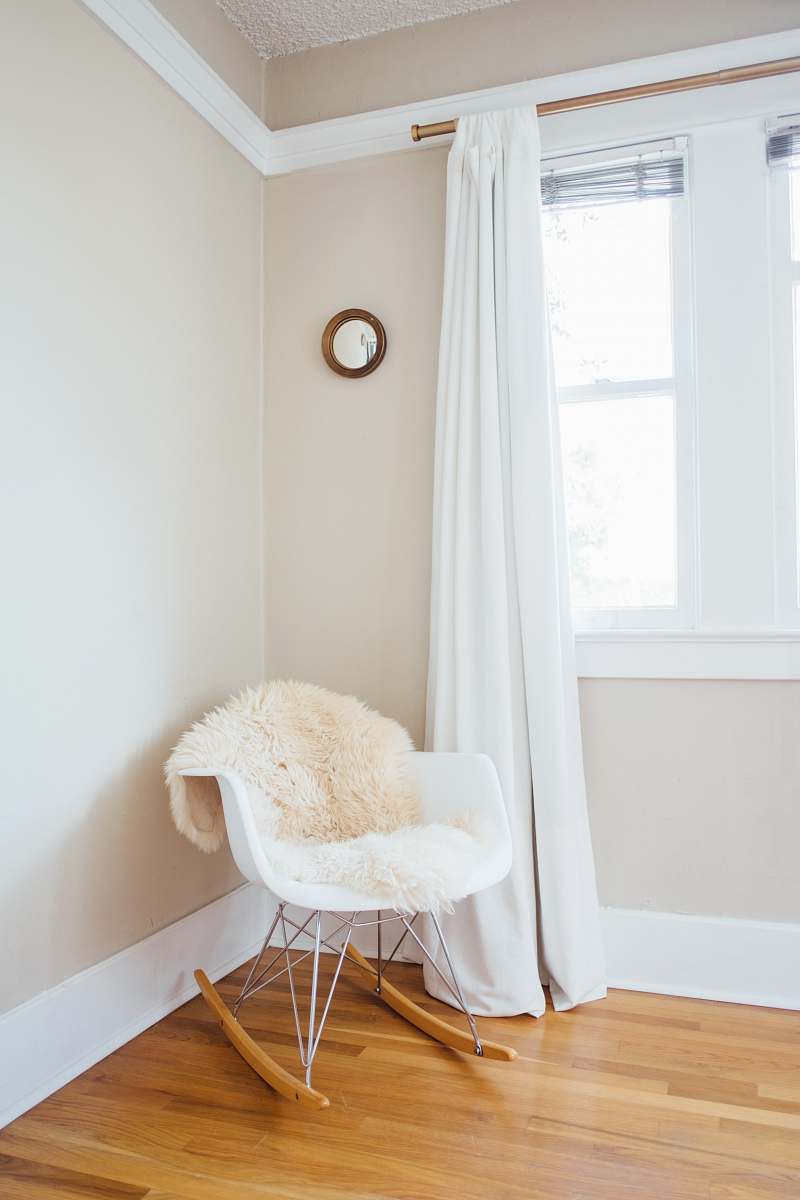 interior white and brown rocking chair near white painted wall and white window curtain home