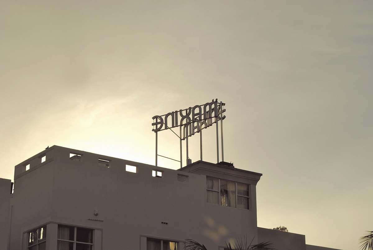 maxine white concrete building under cloudy sky during daytime skyline