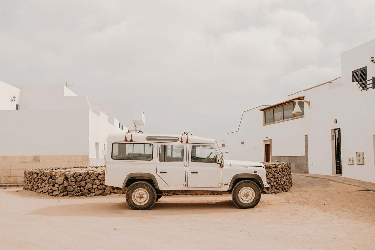 spain white SUV parked beside pile of woods graciosa