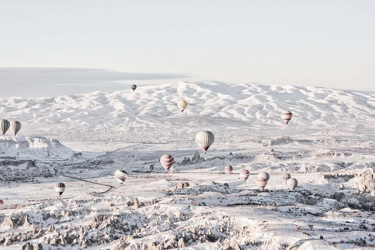 grey assorted-color air balloons below snowland at daytime hot air balloon