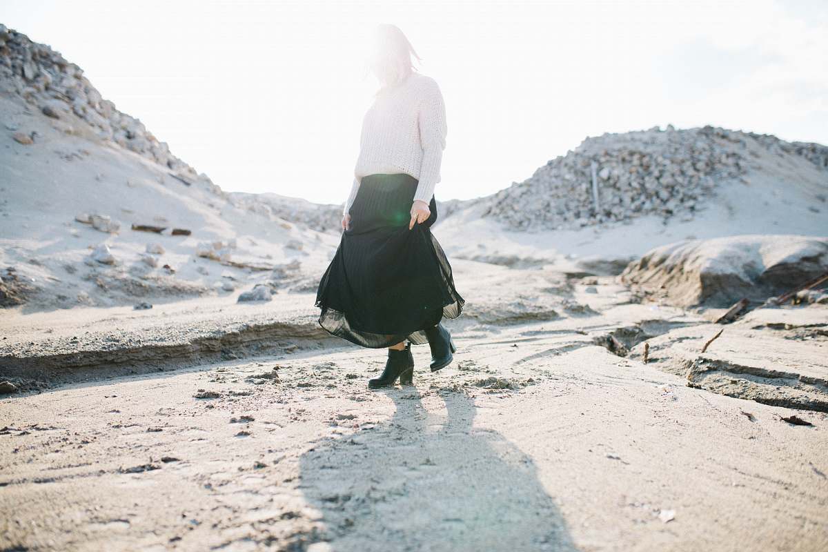 skirt woman in black skirt walking on gray flooring fashion