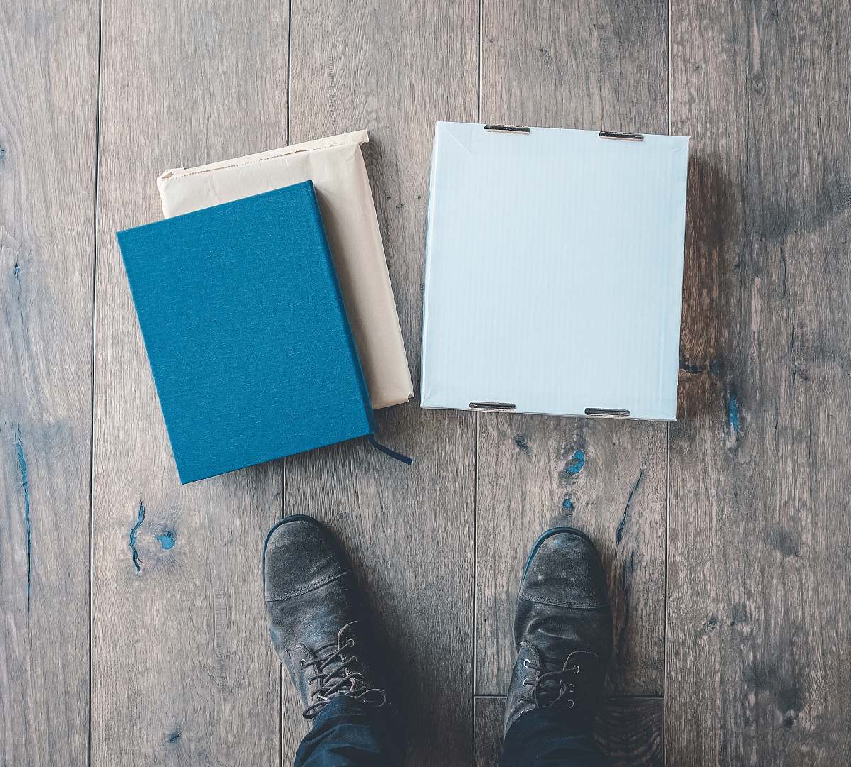 clothing person standing near three boxes shoe