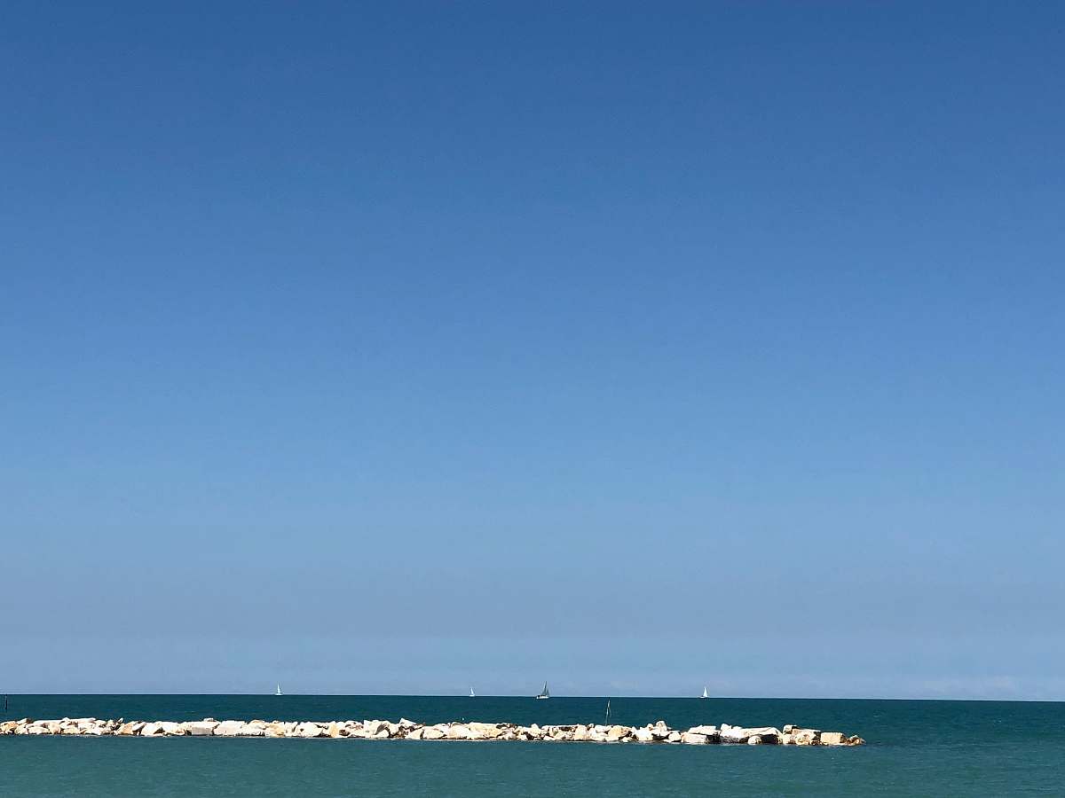 building landscape photo of the ocean with stone dock tower