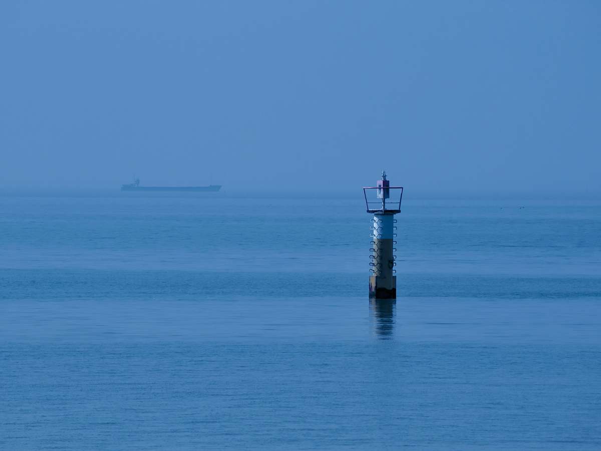 building white and brown tower on calm sea tower
