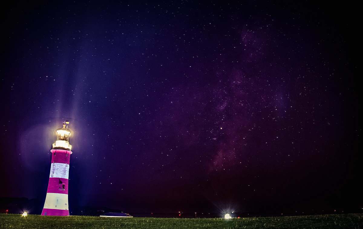 blue lighthouse turned on near green grass field smeaton's tower