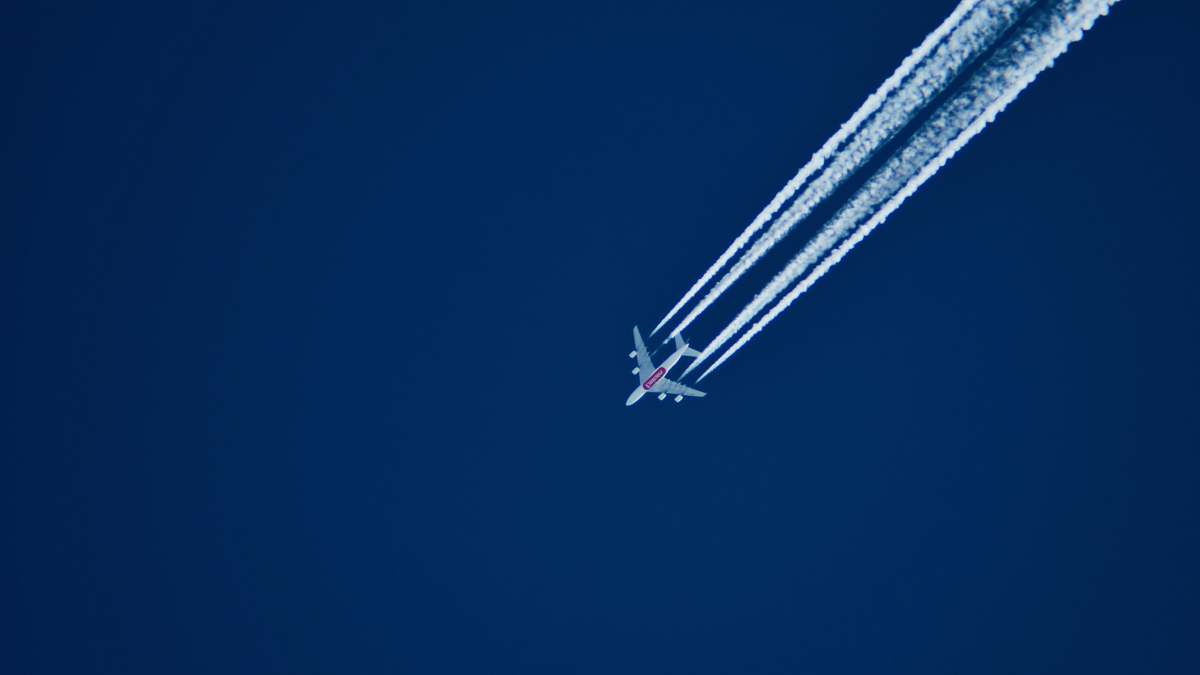 airplane aerial photo of airplane with contrail during daytime aircraft