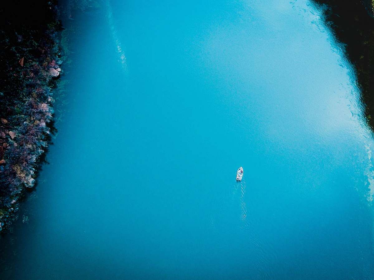 water aerial photo of boat sailing on sea sea life