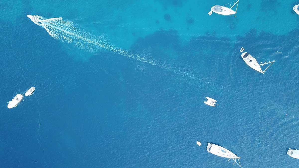 outdoors aerial photo of powerboats in ocean water