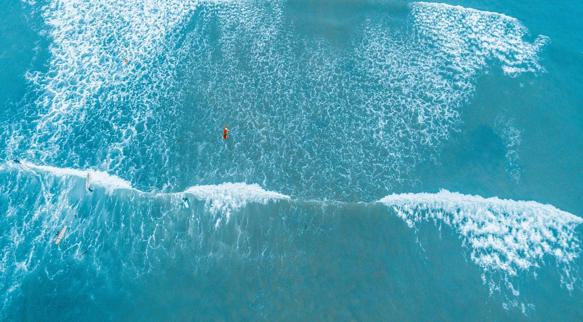 water aerial photography of barrel wave ocean