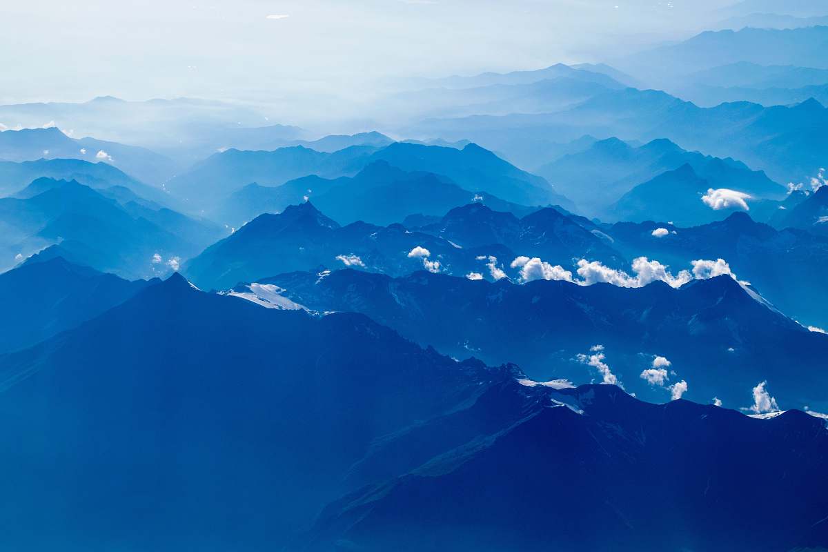 nature aerial photography of mountain under clear blue sky mountain