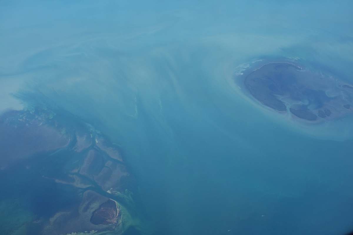 water aerial photography of mountains caribbean sea