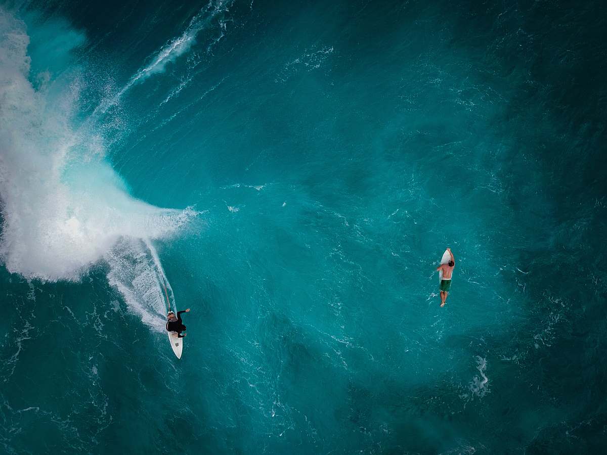 ocean aerial photography of two persons surfing sea