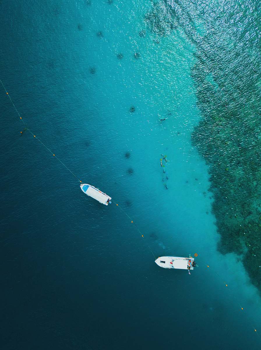 malaysia aerial photography of two white motor boats on calm body of sea pulau sapi