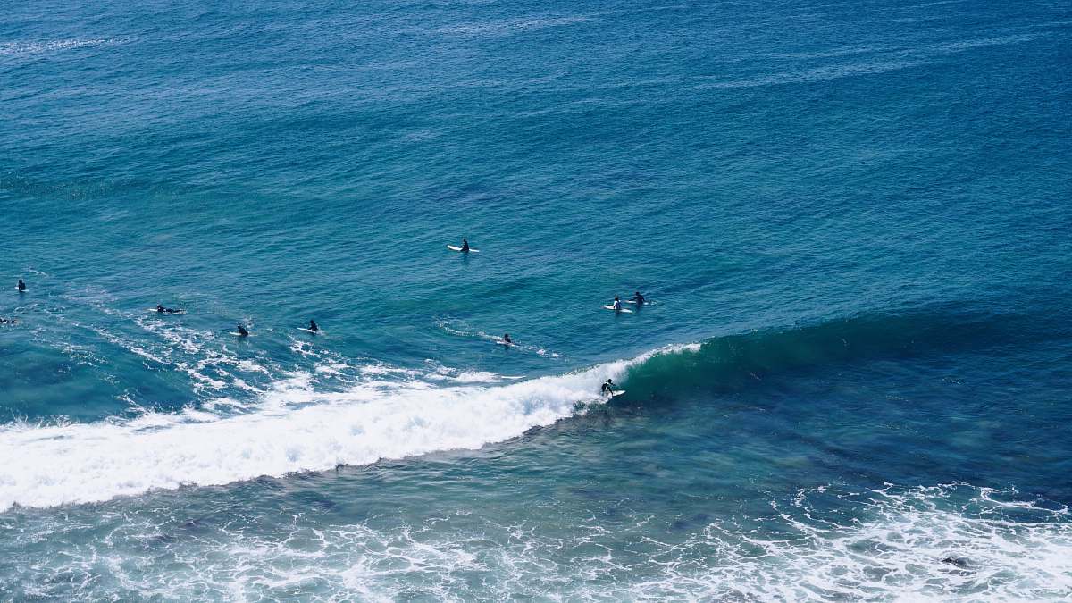 water aerial shot of person surfing on ocean ocean