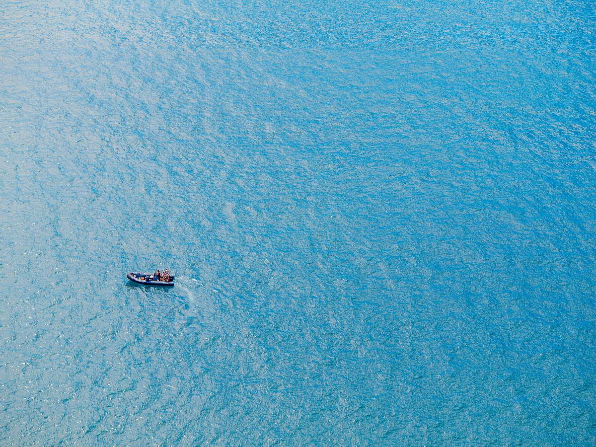 ocean bird's eye view photography of boat on body of water sea