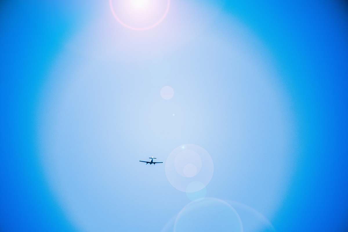 airplane black airplane flying on air lens flare