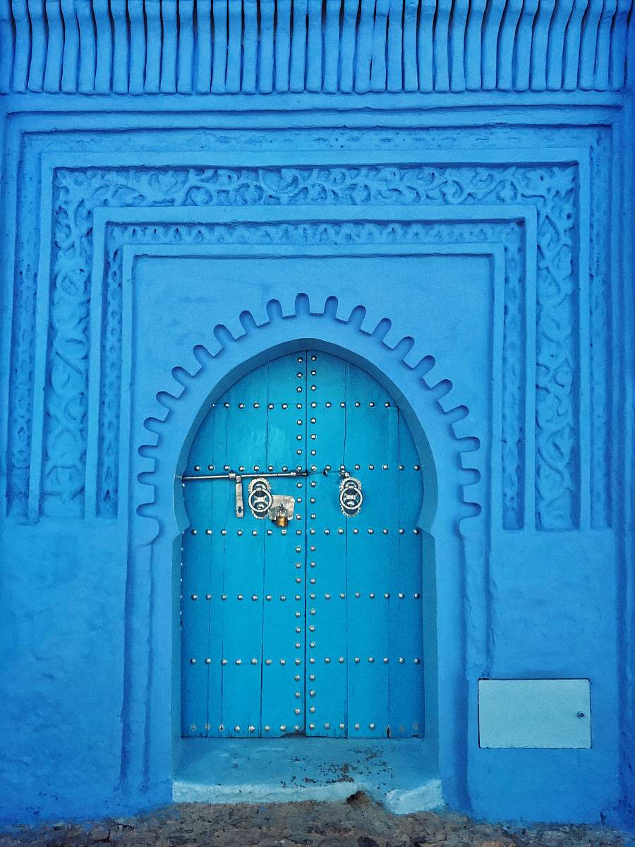 chefchaouen blue painted wall and door at daytime morocco