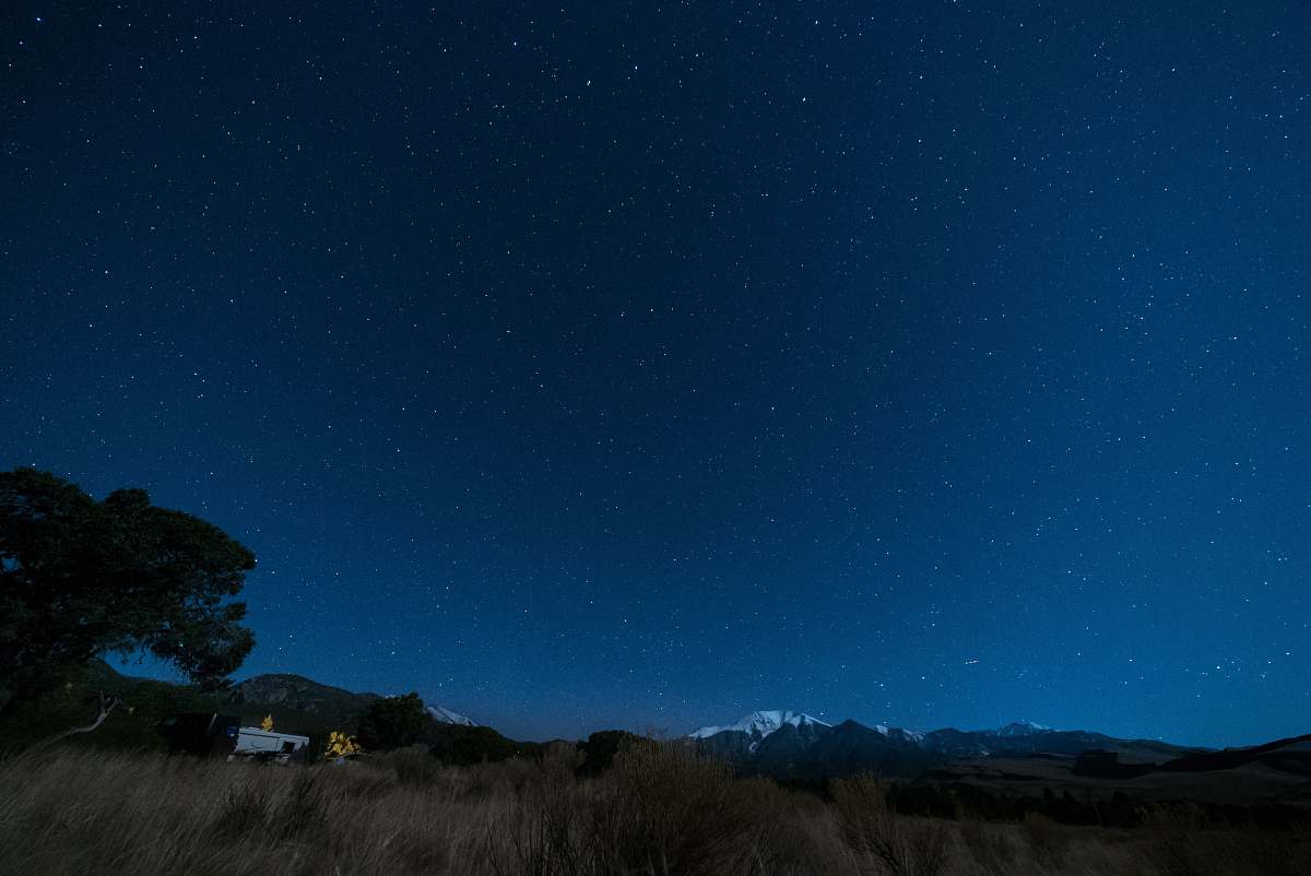 night blue starry skies camping