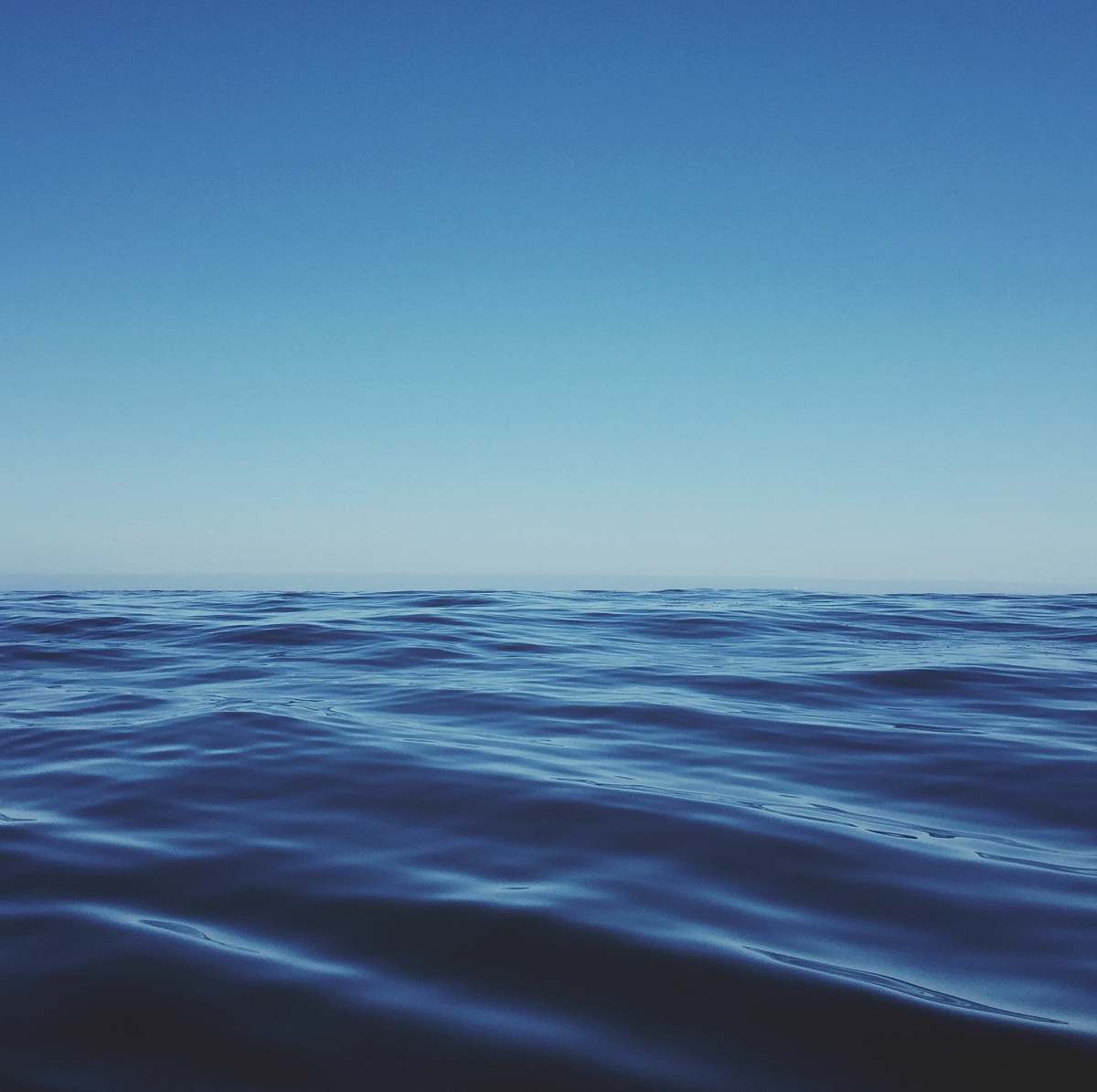 water body of water under clear blue sky ocean