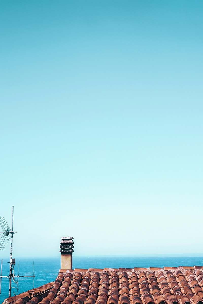 architecture brown roof shingles under calm blue sky building