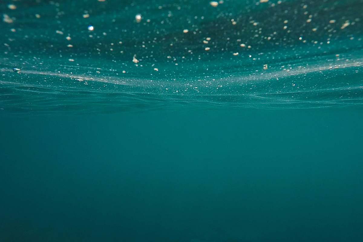 water calm body of water teal