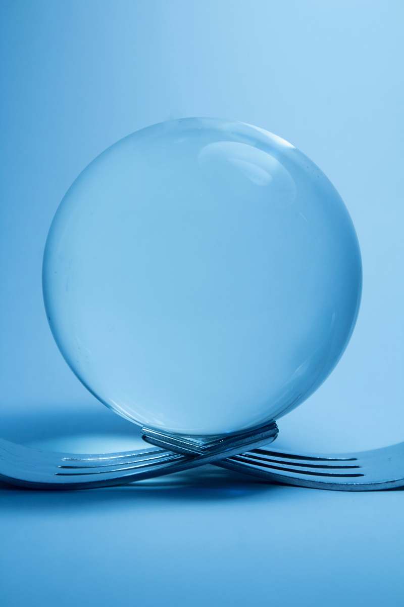 sphere clear glass ball on top of two forks ball