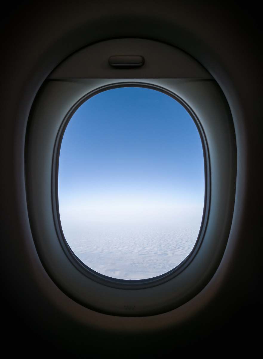 window clear white skies from plane's window view porthole