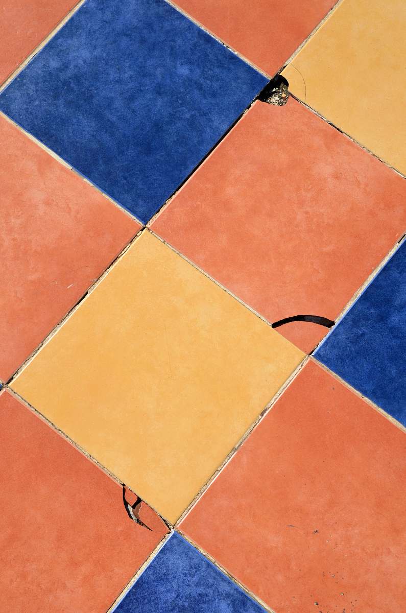 texture close-up photography of blue, orange, and yellow tile surface pattern