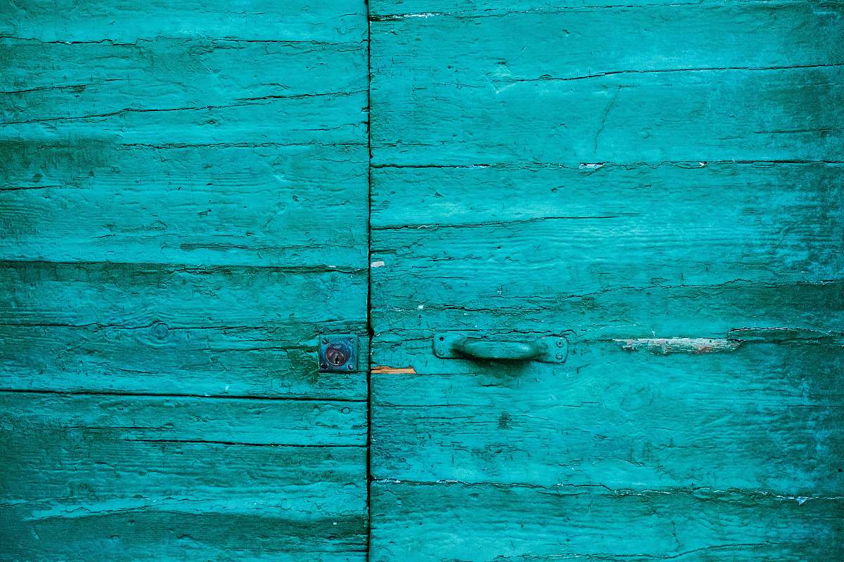 riomaggiore closed teal wooden door italy