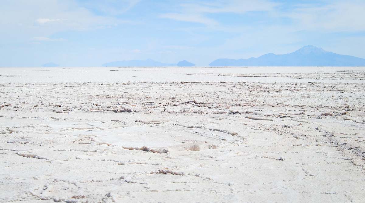 soil desert under blue sky and white clouds at daytime ground