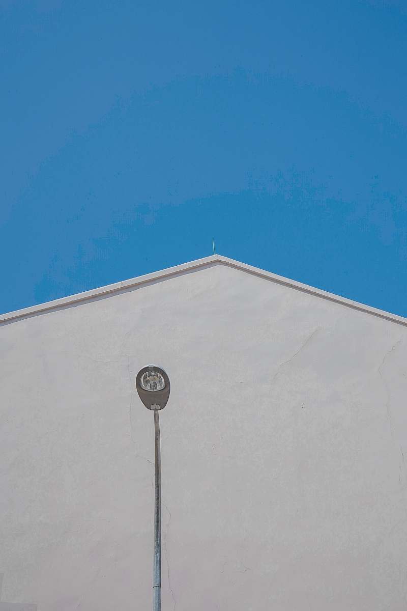 building gray outdoor lamp post near white concrete building during daytime architecture