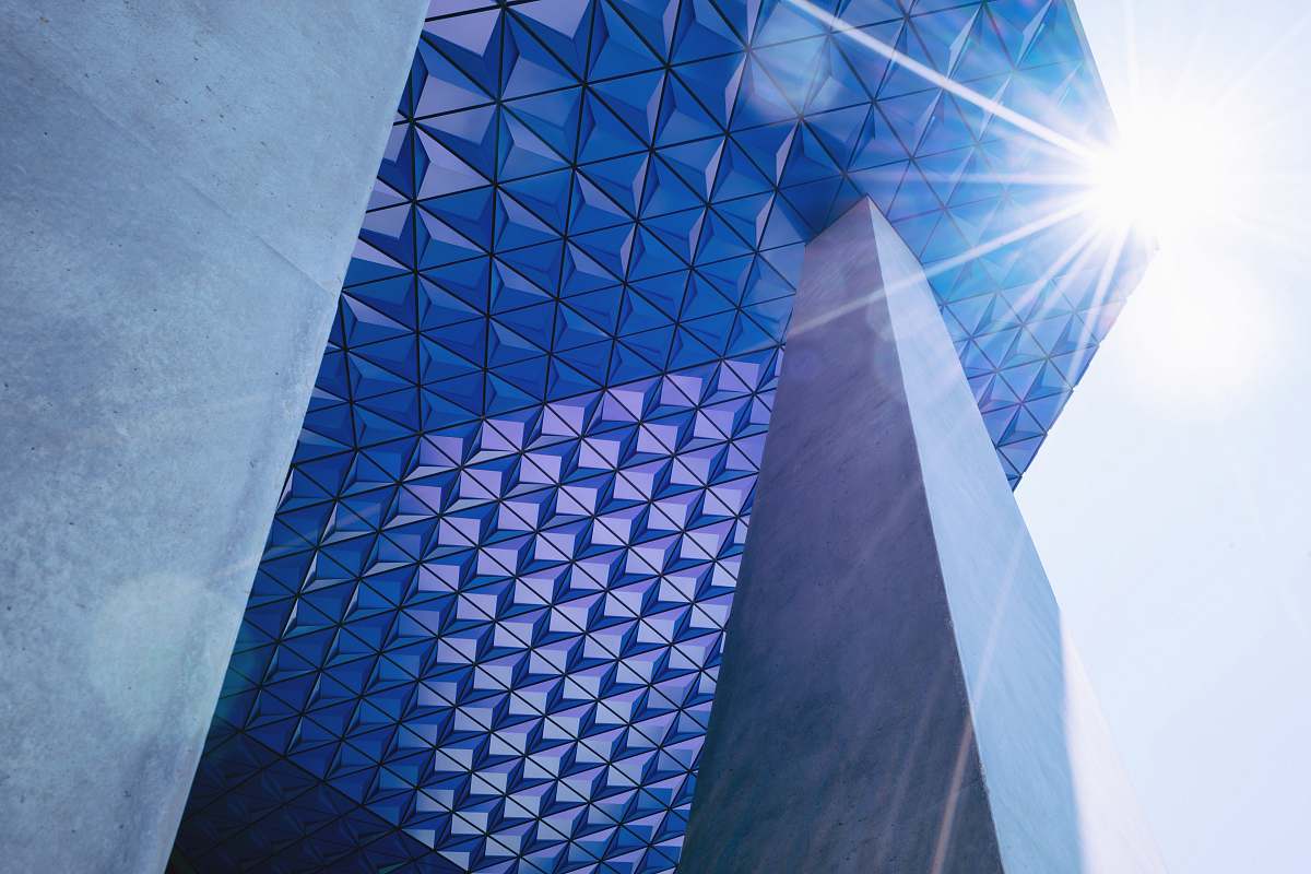 building grey concrete wall leaning on blue glass building during daytime toronto