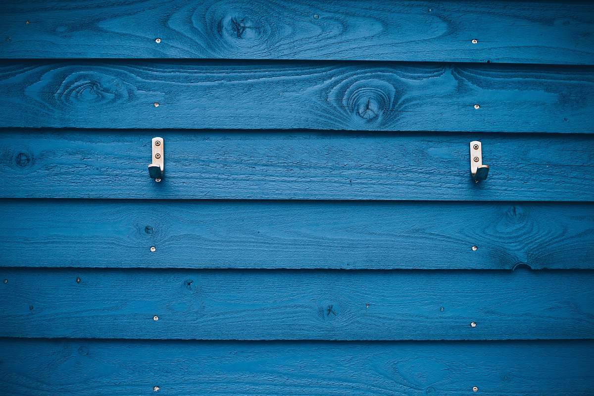 wood grey metal hook on blue wood plank hestehovedet strand