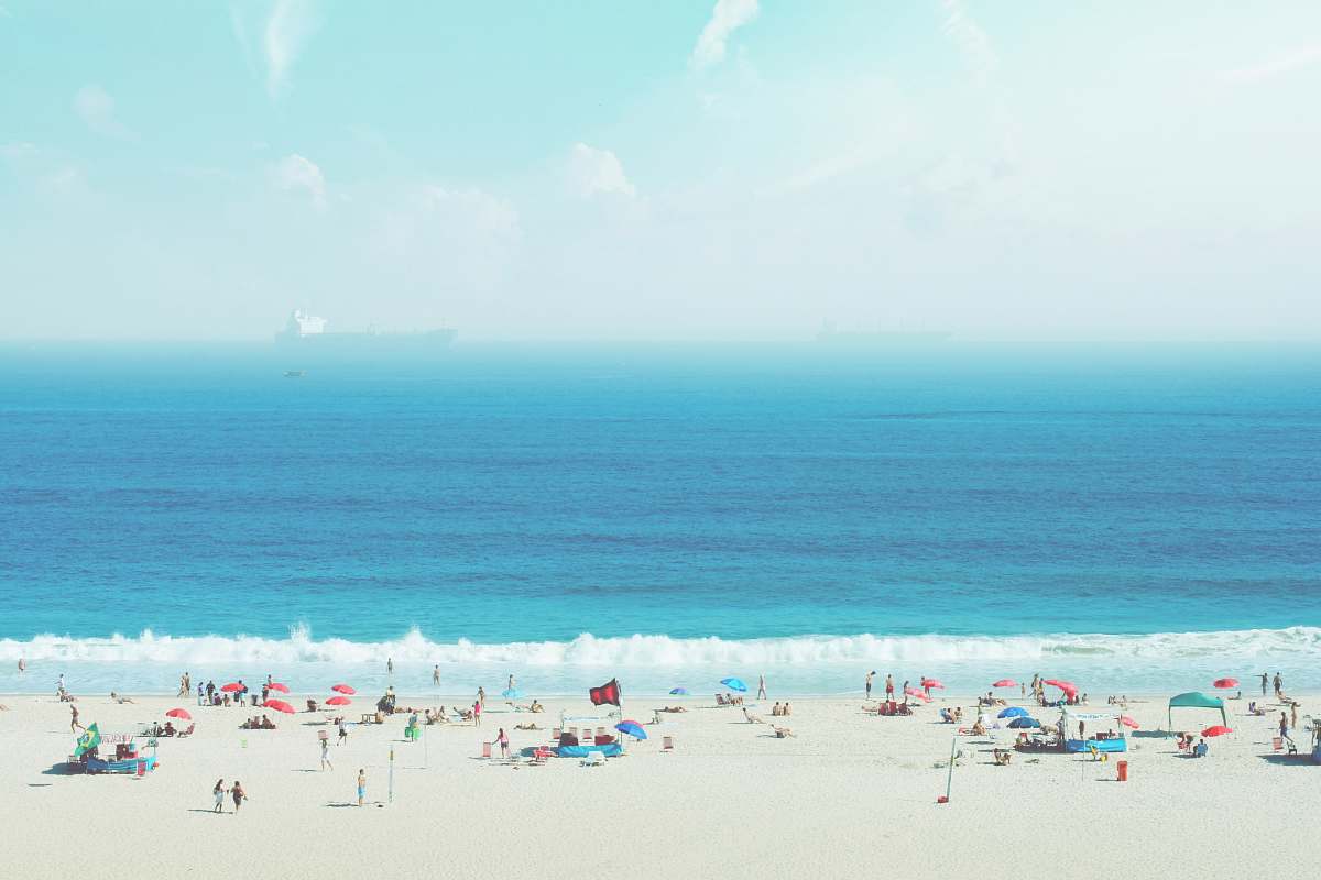ocean group of people on white sand beach beach