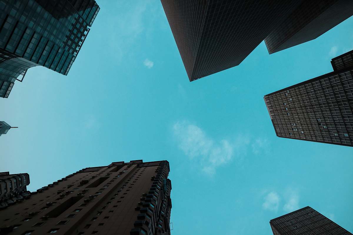 Experience the grandeur of urban architecture with this captivating high angle view photography of towering office buildings. This striking image showcases the intricate details of the skyscrapers as they stretch towards the sky, offering a unique perspective that is perfect for use in business presentations, real estate marketing, or urban development projects. Ideal for architects, designers, and city explorers alike, this photo captures the essence of modern city life.