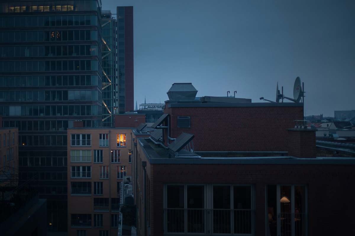 building high rise buildings under gray clouds at nighttime hamburg