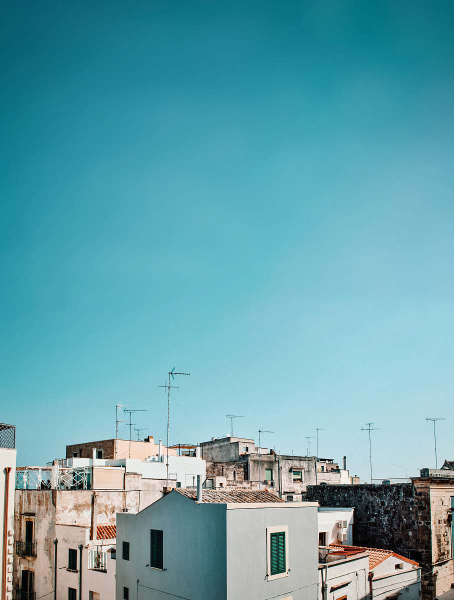 antenna high rise buildings under teal sky during daytime electrical device