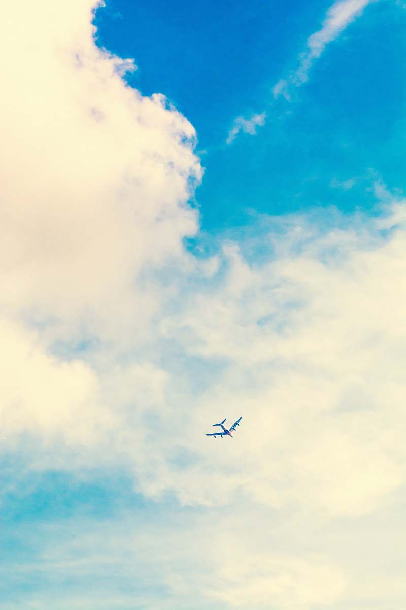 airplane low angle photo of airplane and white clouds during daytime sky