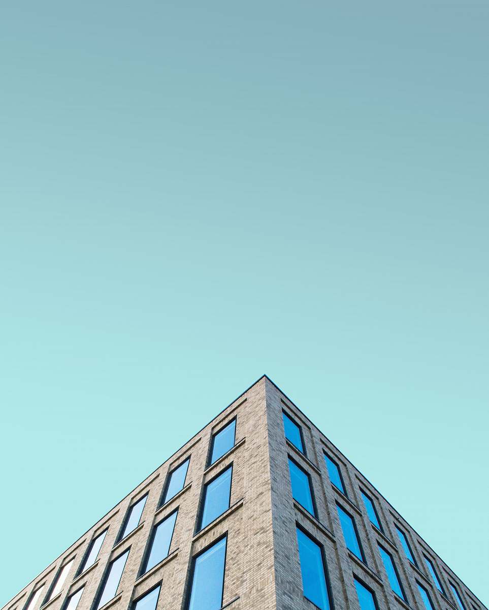 triangle low angle photography of brown building structrure slough
