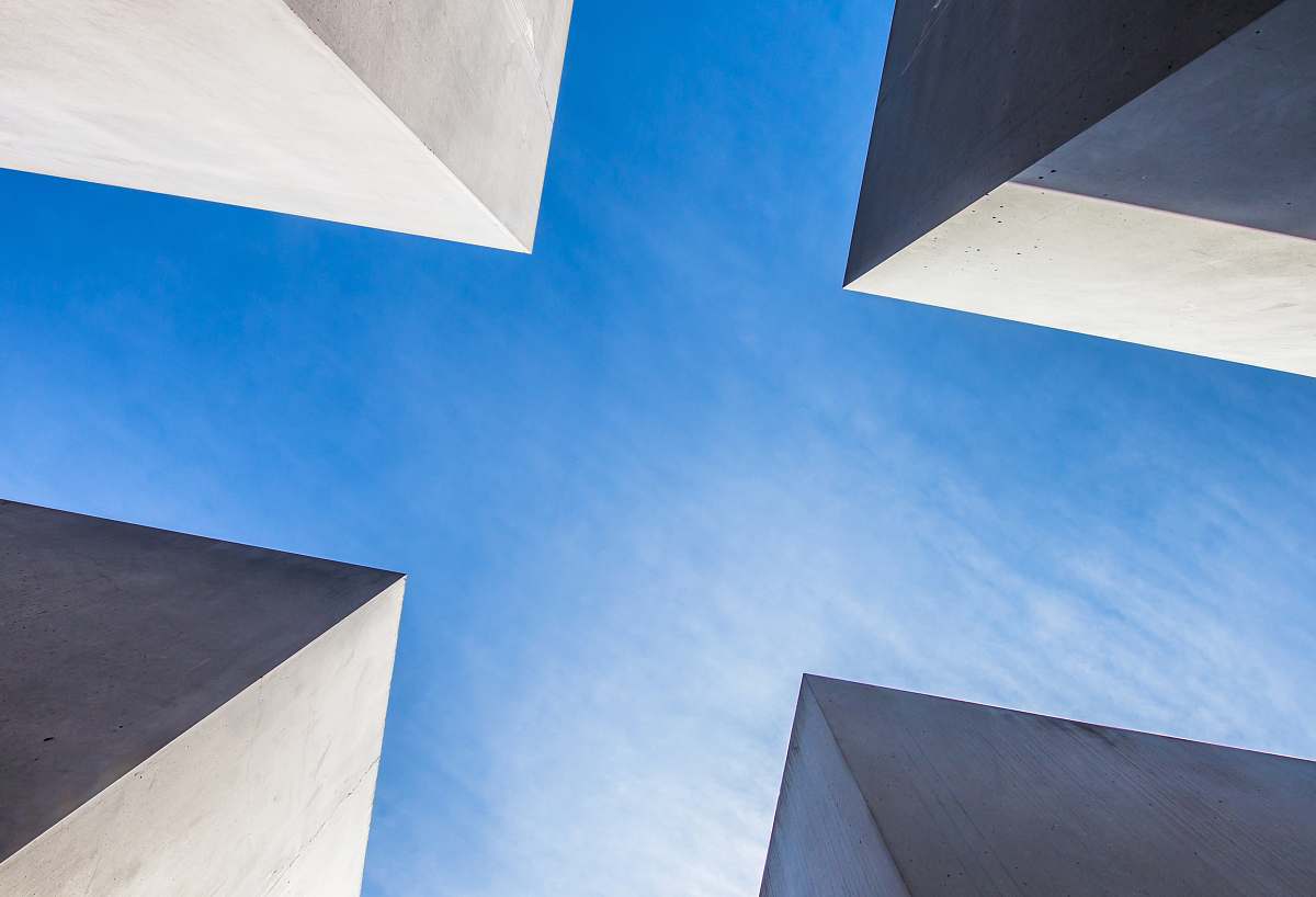 germany low angle photography of concrete buildings under blue sky sky