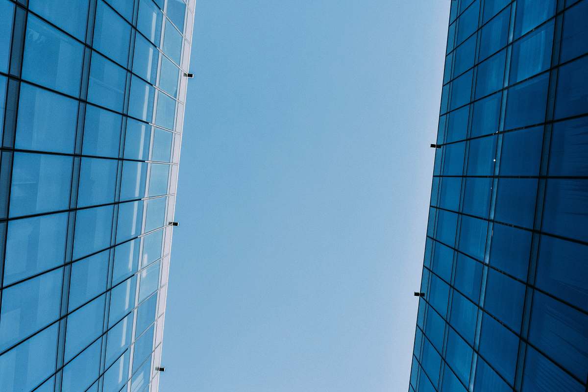 building low angle photography of curtain wall building at day time housing