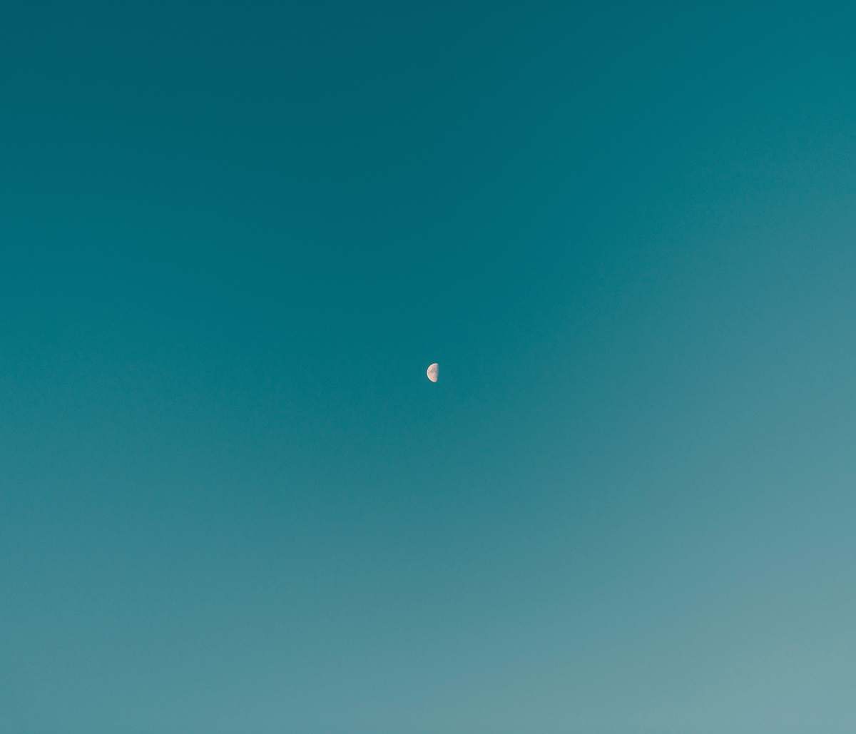 nature low-angle photography of half moon teal