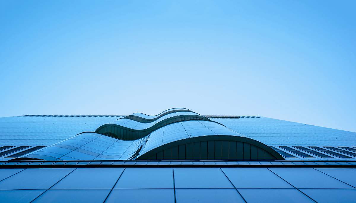 building low-angle photography of high-rise building under blue and white sky at daytime modern