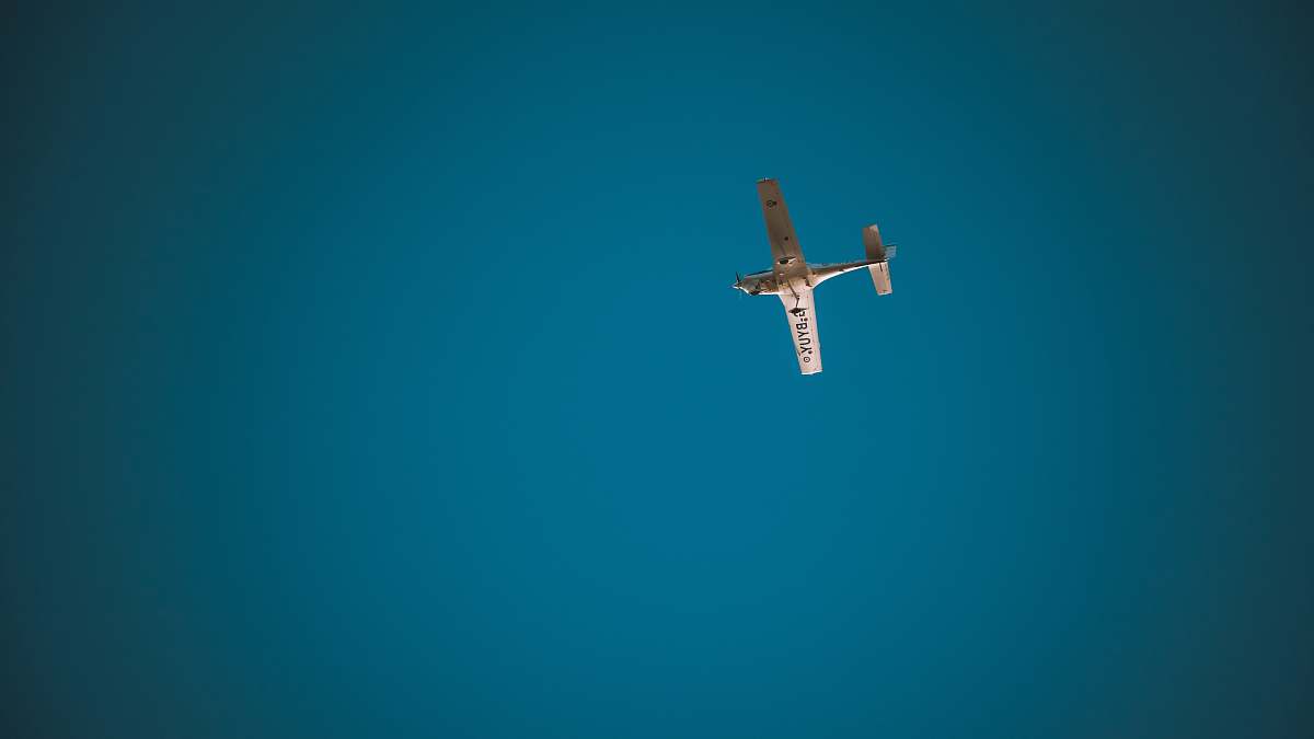 teal low angle photography of monoplane airplane